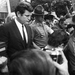 Sen. Edward Kennedy is escorted by troopers as he leaves court on July 25, 1969 in Edgartown, Mass., after pleading guilty to a charge of leaving the scene of the accident which killed aide Mary Jo Kopechne.